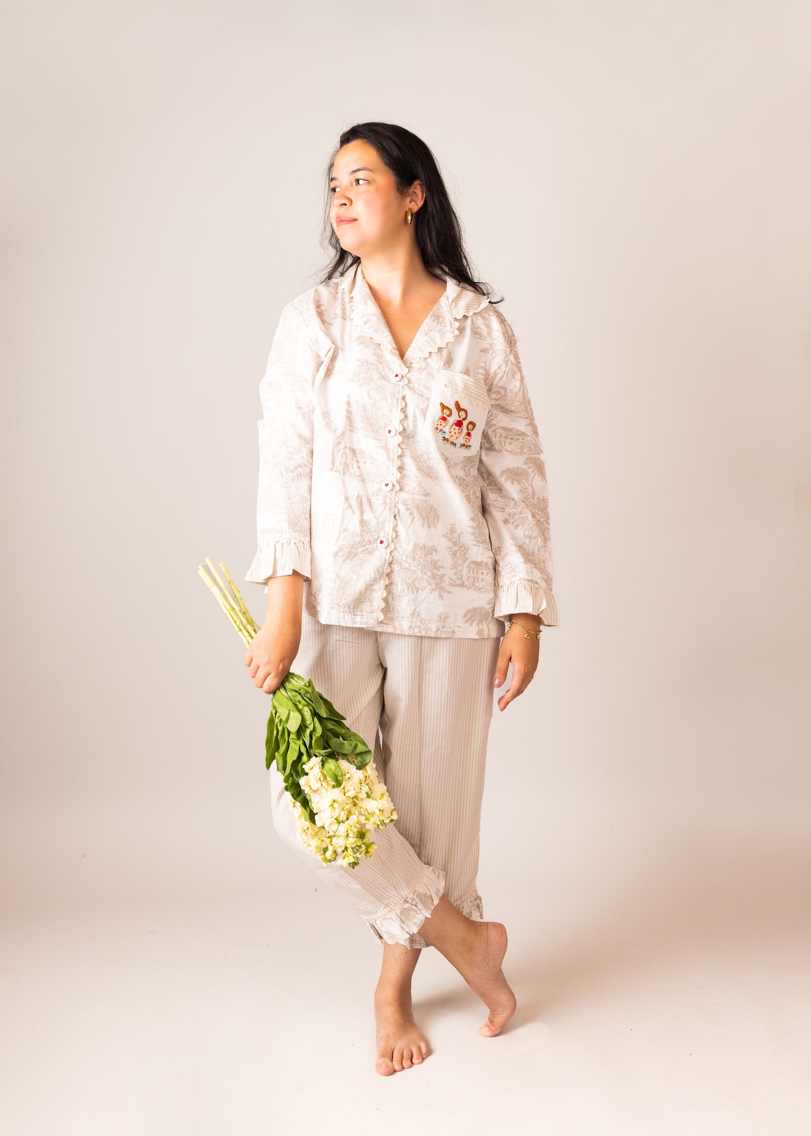 model wearing a cozy mum pyjama set holding flowers 