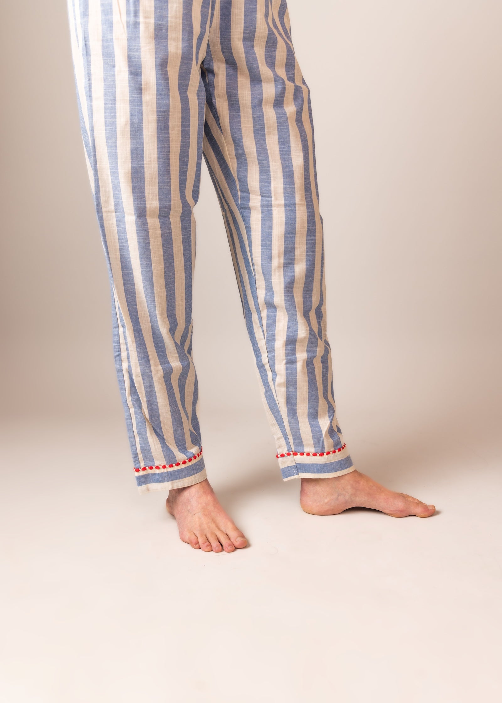 Striped BLUE pajama pants worn by a person on a plain background