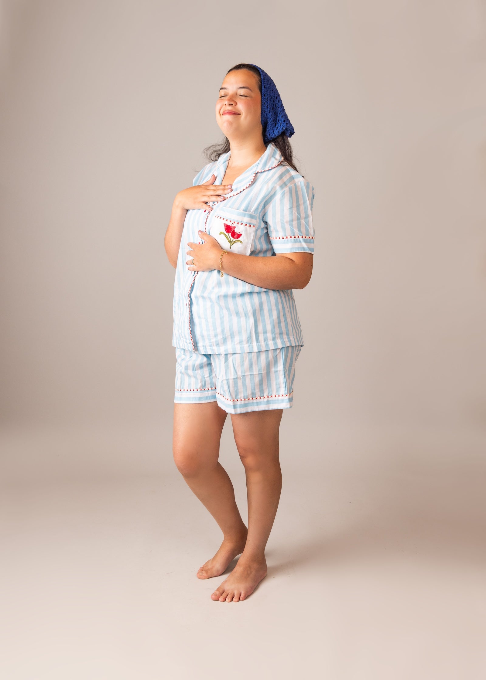Woman wearing a light blue STRIPED pajama set 