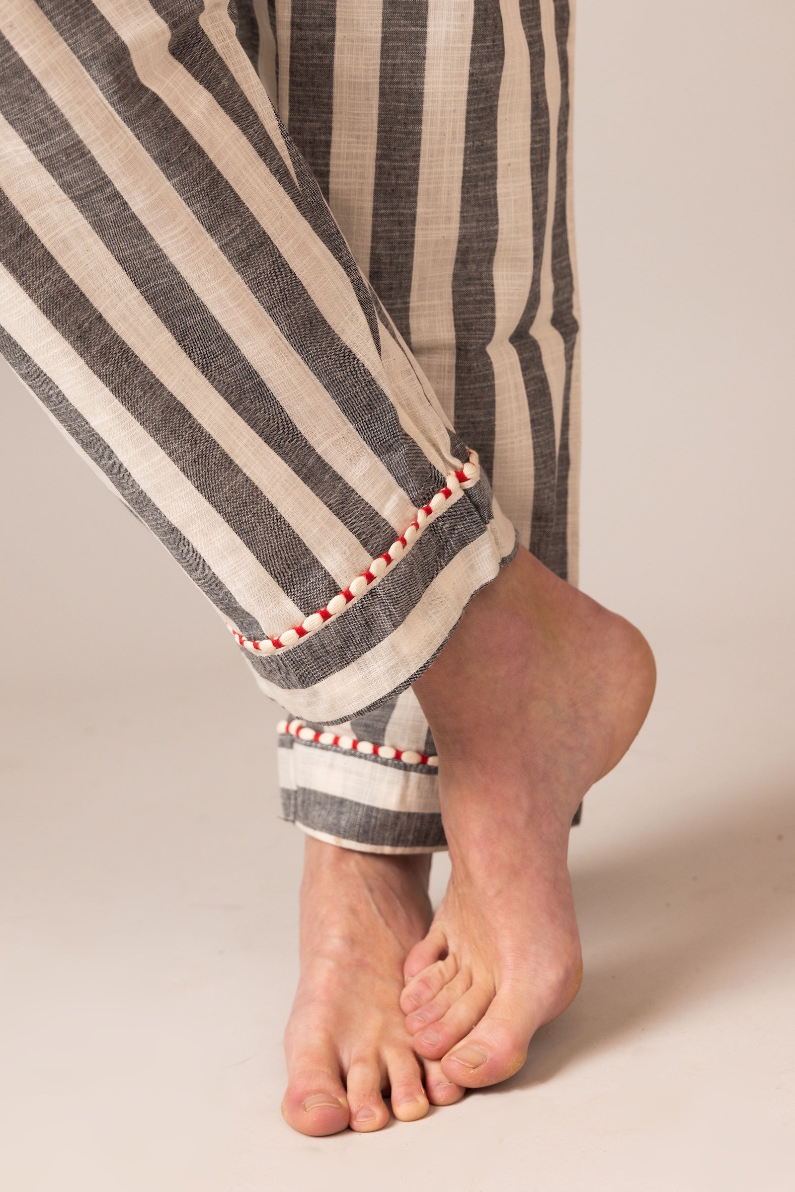 Close-up of striped pajama pants with a neutral background